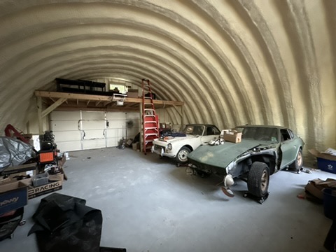 The 240Z and a Datsun Roadster inside Quinn’s arched workshop