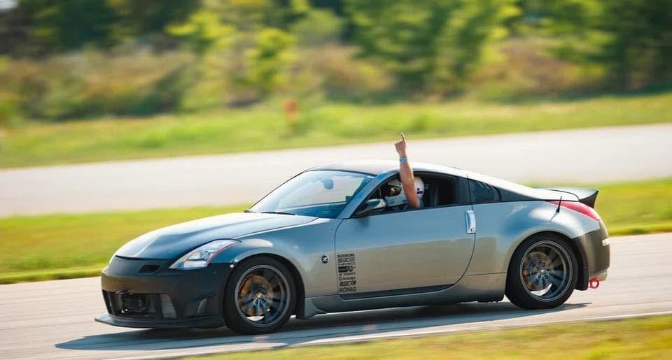 Quinn driving a Nissan 350Z on track at Harris Hill Raceway