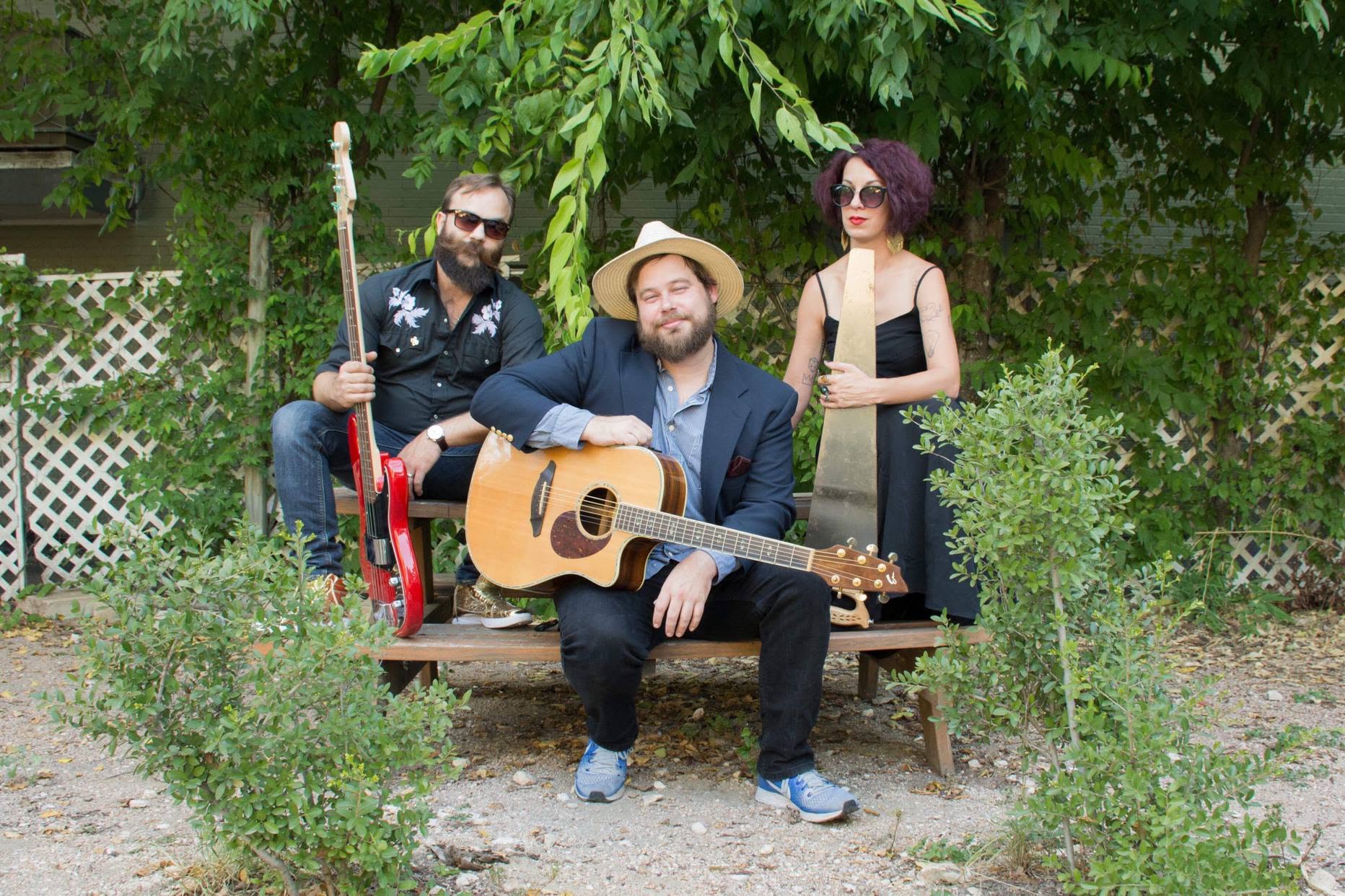 The Carry Ons posed outdoors with their instruments