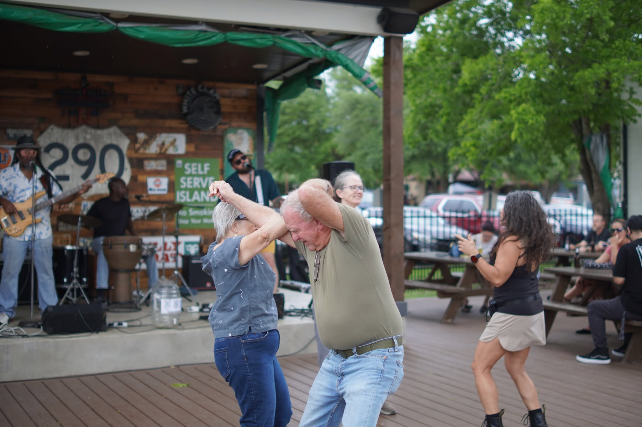 Couples dancing on a patio with a live band behind them