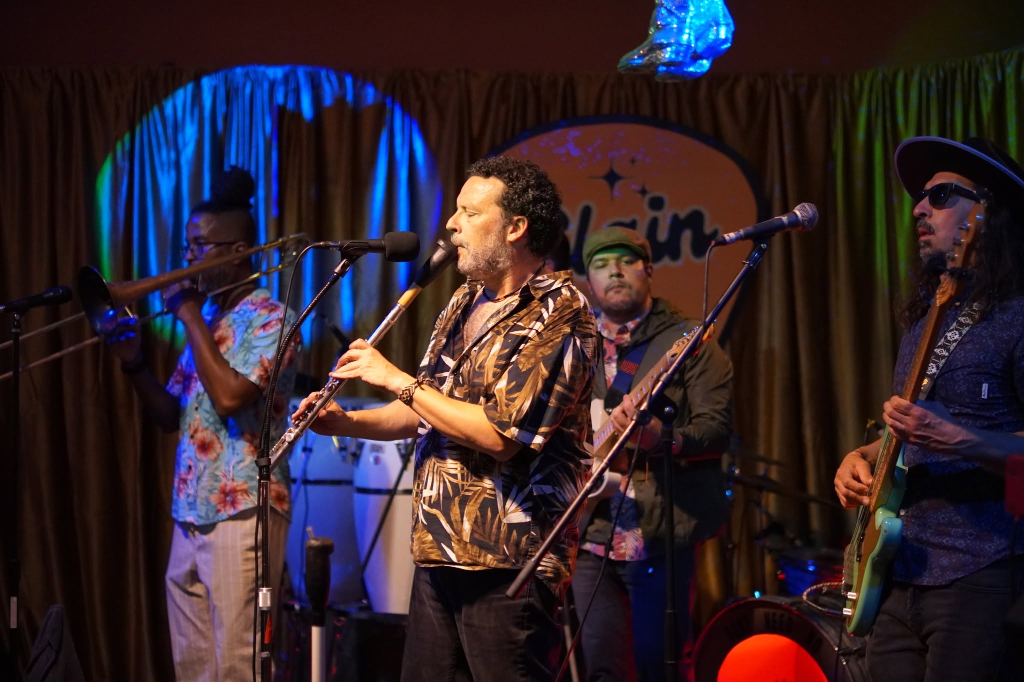 Wind players performing alongside a rhythm section