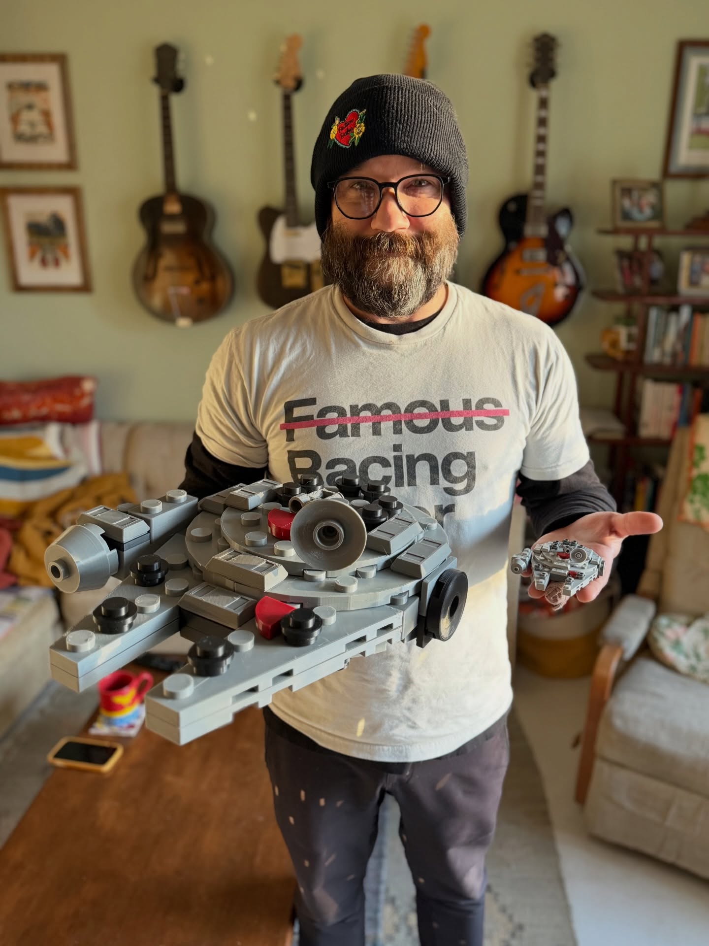 Quinn Walton holding a scaled-up 3D printed Millennium Falcon