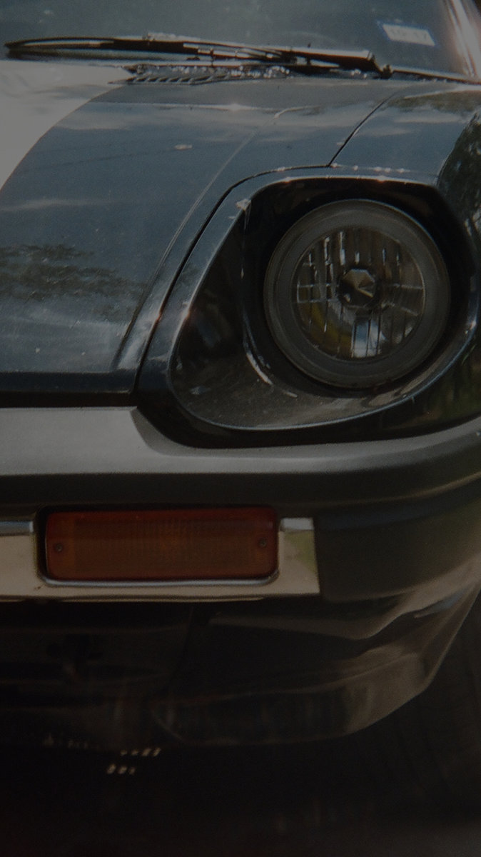 Detail of a vintage Datsun in Quinn's garage
